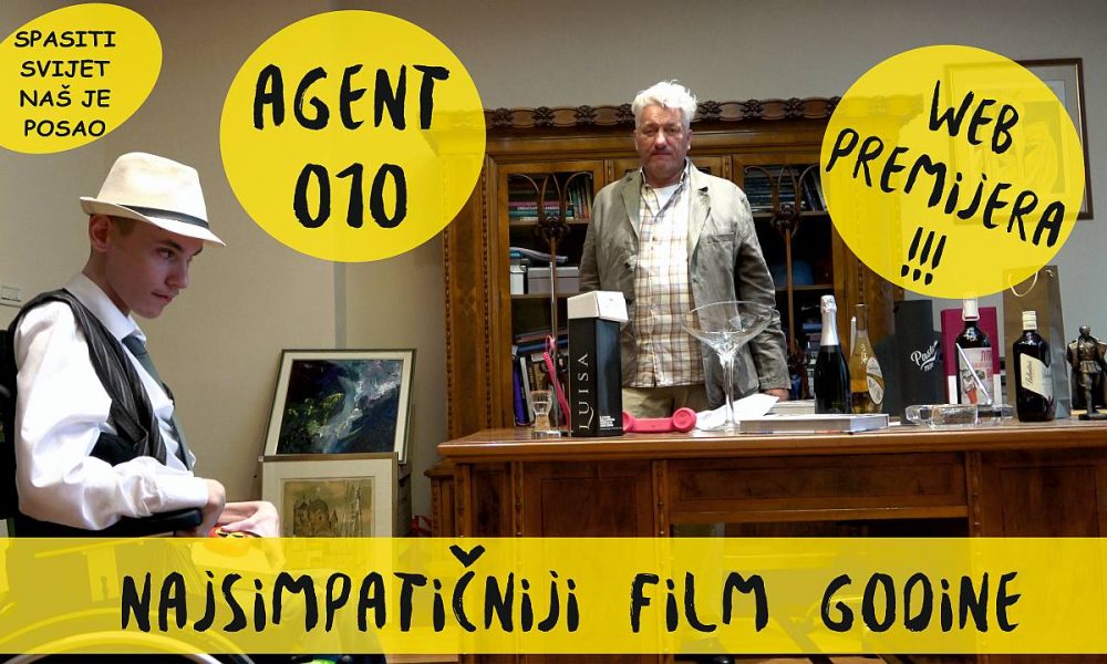 Na slici je reklama za film Agent 010. Na slici su dva muškarca u baru. Muškarac s lijeve strane nosi odijelo i šešir, a muškarac s desne strane nosi karirani sako i šešir. U pozadini se vidi dio bara s raznim bocama alkohola i blagajnom.