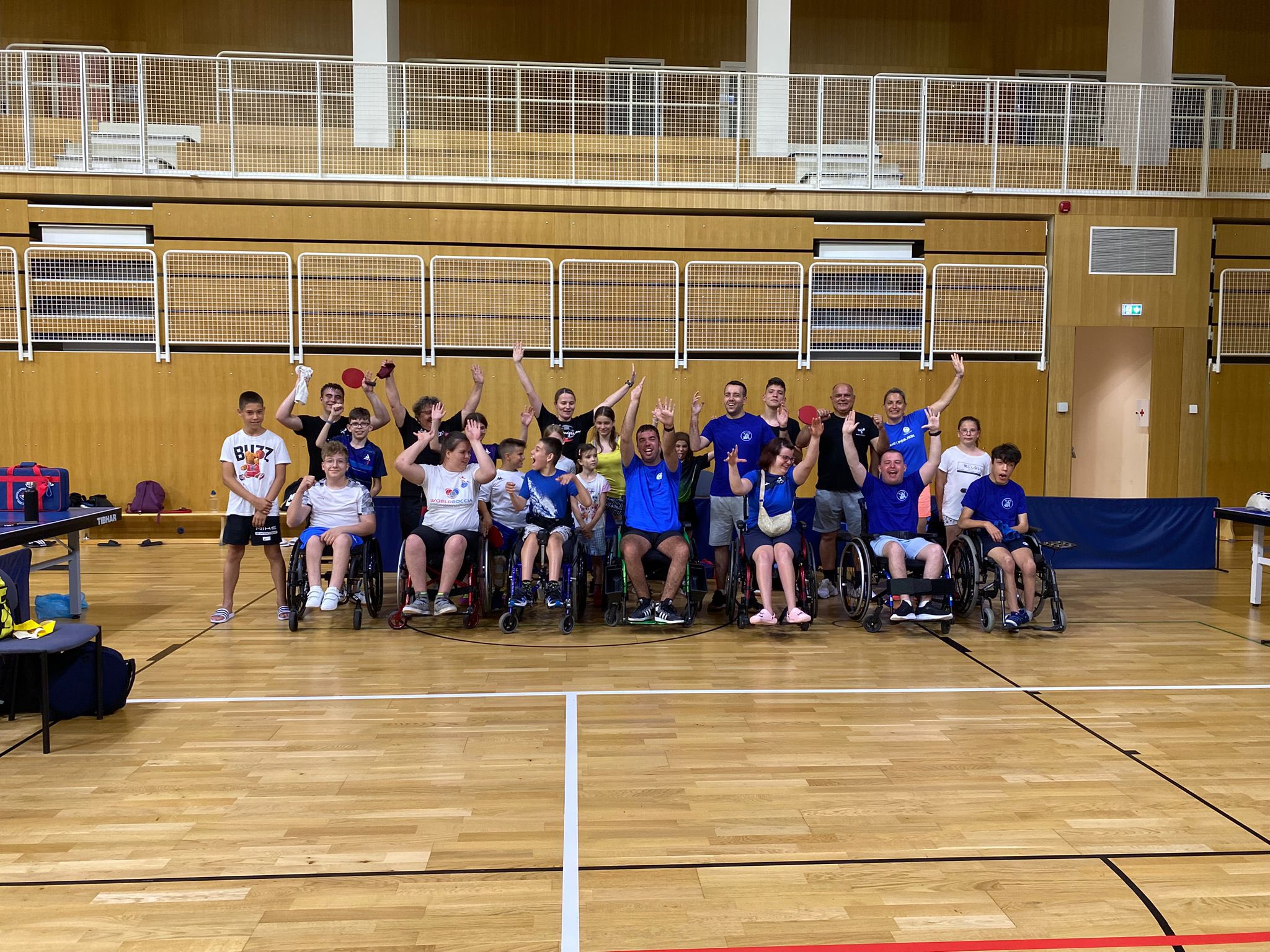 Fotografija prikazuje ljude u invalidskim kolicima sportskoj dvorani