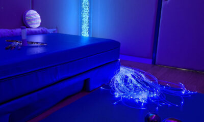 Prostor senzorne sobe u plavom ambijentalnom svjetlu. Na podu je plavi madrac, a pored njega svjetleća vlakna optičkih niti koje svijetle u plavim tonovima. U pozadini se nalazi stup s mjehurićima i svjetlom, dok su na madracu raspoređeni predmeti poput pješčanog sata, šarenih svjetlećih štapića i reflektirajuće lopte. Prostor djeluje umirujuće i osmišljen je za senzornu stimulaciju.