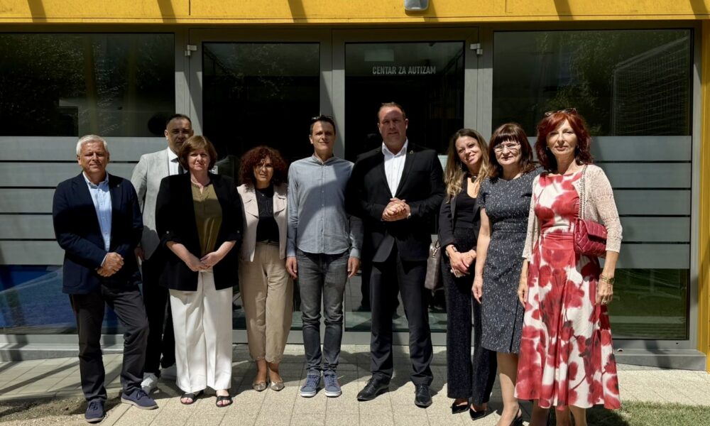 Fotografija prikazuje nekoliko ljudi ispred Centra za autizam.