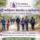 Fotografija prikazuje grupu ljudi kako zajedno hodaju šumskom stazom, okruženi zelenilom i drvećem. Atmosfera je mirna i podržavajuća, a zajednički hod simbolizira solidarnost i zajedništvo. U gornjem dijelu nalazi se tekst koji poziva na sudjelovanje u akciji „50 milijuna koraka za epilepsiju“, koju organizira Hrvatska udruga za epilepsiju. Poruka ističe važnost razumijevanja i destigmatizacije epilepsije, uz emotivan naglasak: „Svaki korak je znak podrške osobama s epilepsijom“. Vizualno i tekstualno, fotografija prenosi toplinu, zajedništvo i poziv na aktivno sudjelovanje u podršci osobama koje žive s epilepsijom.