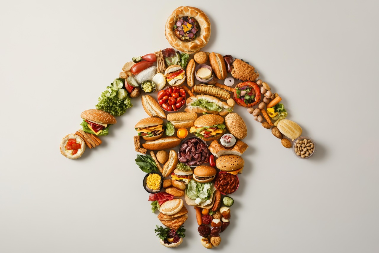Fotografija prikazuje ljudski lik sastavljen u potpunosti od hrane, složen tako da različite namirnice tvore oblik osobe raširenih ruku i nogu.