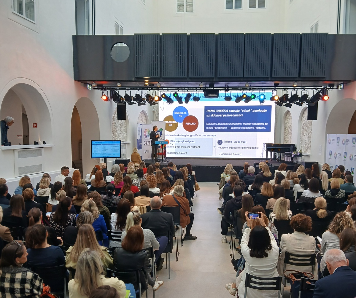 Publika prati izlaganje o mentalnom zdravlju na konferenciji u ispunjenoj dvorani.
